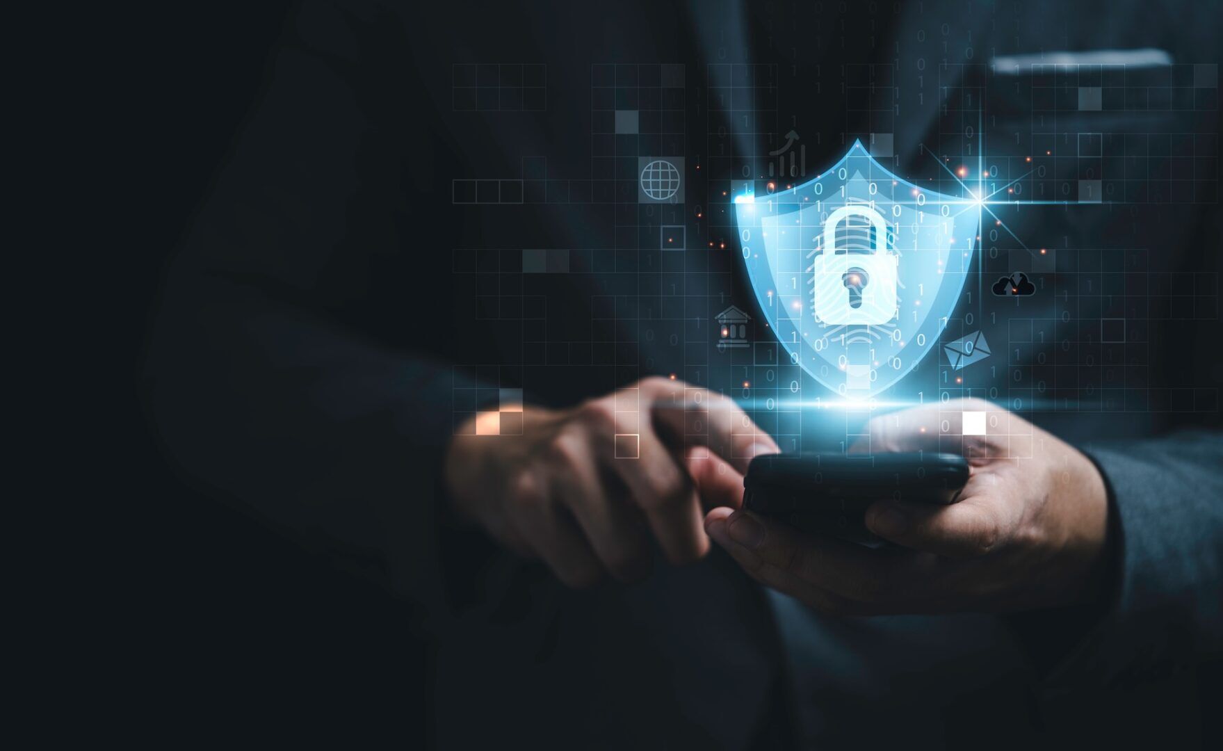 A person in a suit uses a smartphone with a glowing digital shield and padlock icon hovering above it, symbolizing cybersecurity and data protection.