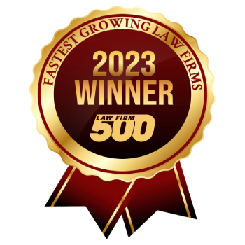 Gold and red badge with the text "Fastest Growing Law Firms," "2023 Winner," and "Law Firm 500," indicating an award for law firms with rapid growth.