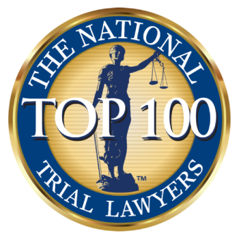 Circular gold and blue badge with the words "The National Trial Lawyers" around the edge, "Top 100" in large white text in the center, and the image of Lady Justice holding scales in the background.