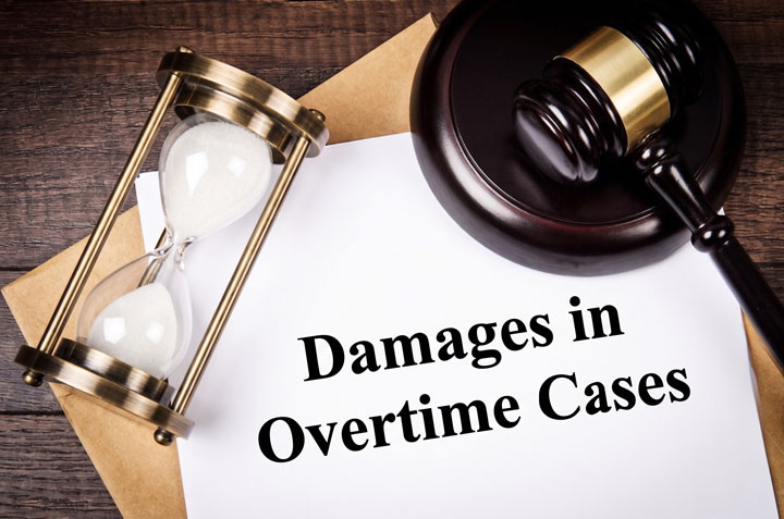 A gavel, an hourglass, and a brown folder rest on a wooden table next to a document titled "Damages in Overtime Cases.