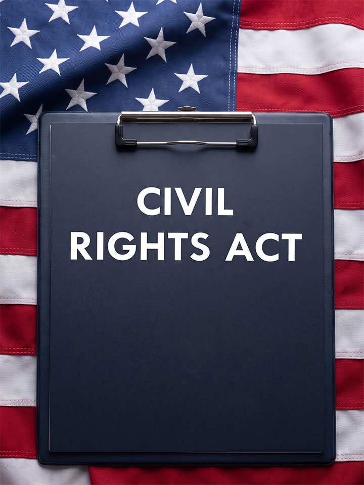 A clipboard labeled "CIVIL RIGHTS ACT" is placed on top of an American flag.