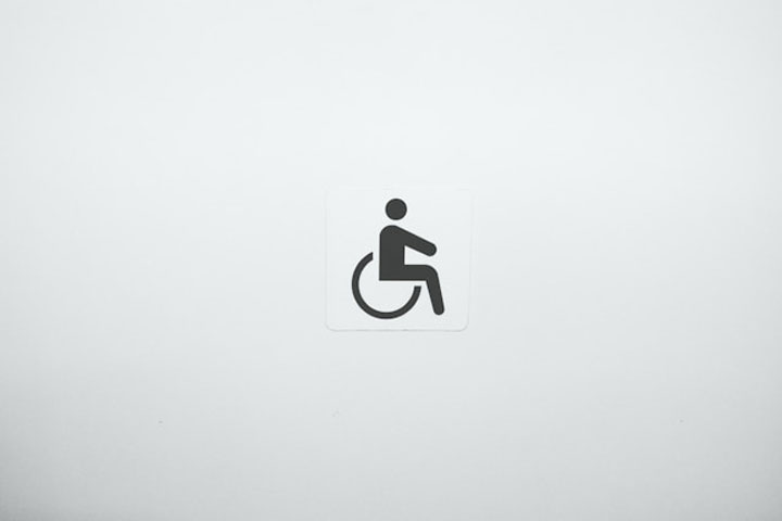 A black wheelchair accessibility symbol is centered on a plain white background.