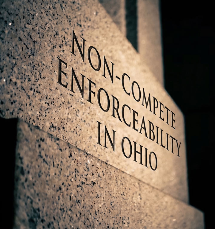 Stone wall engraved with the words "NON-COMPETE ENFORCEABILITY IN OHIO," suggesting a legal or regulatory topic related to employment law in Ohio.