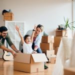 Family moving boxes into a new home