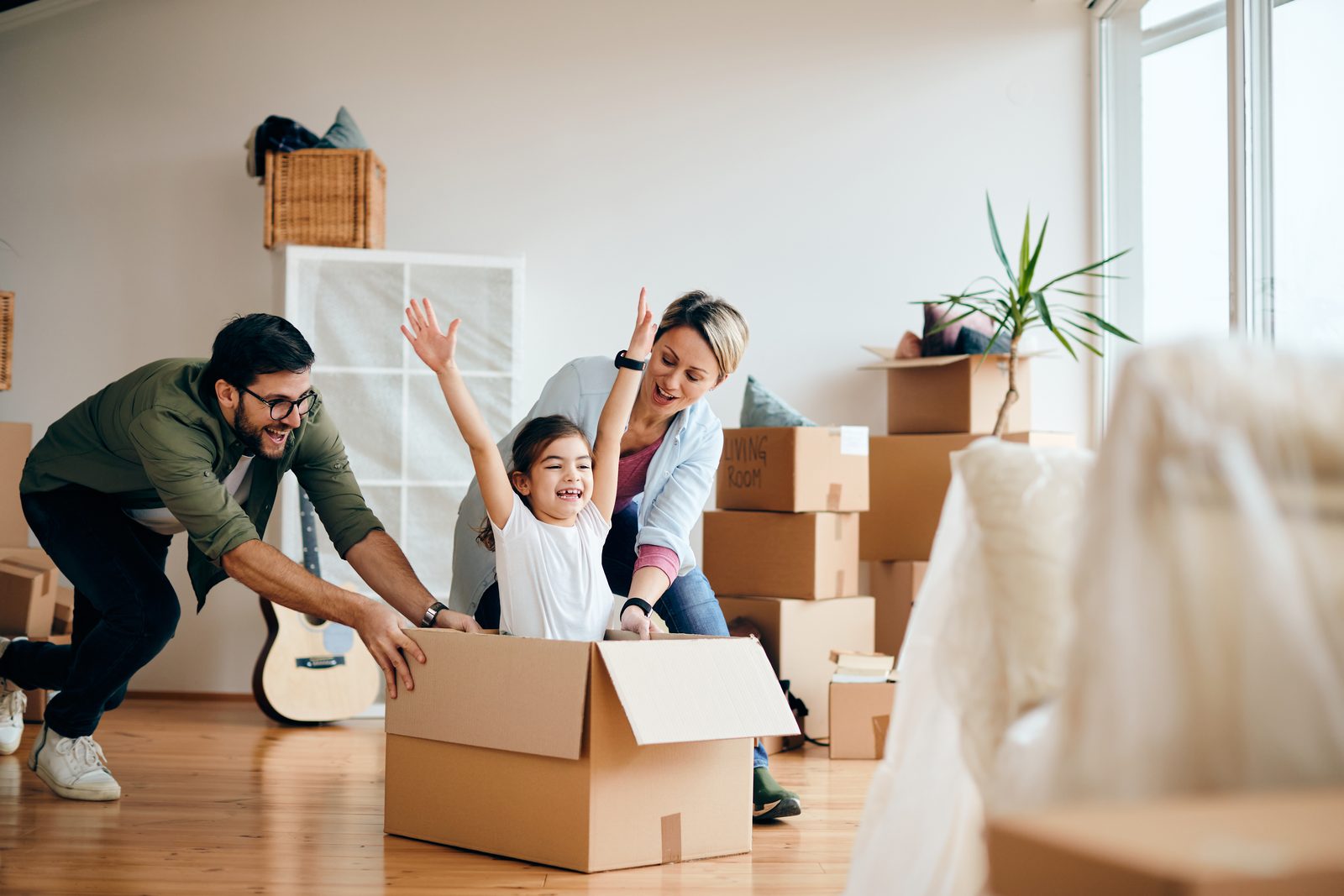 Family moving boxes into a new home