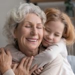 Grandmother embracing her grandchild at home