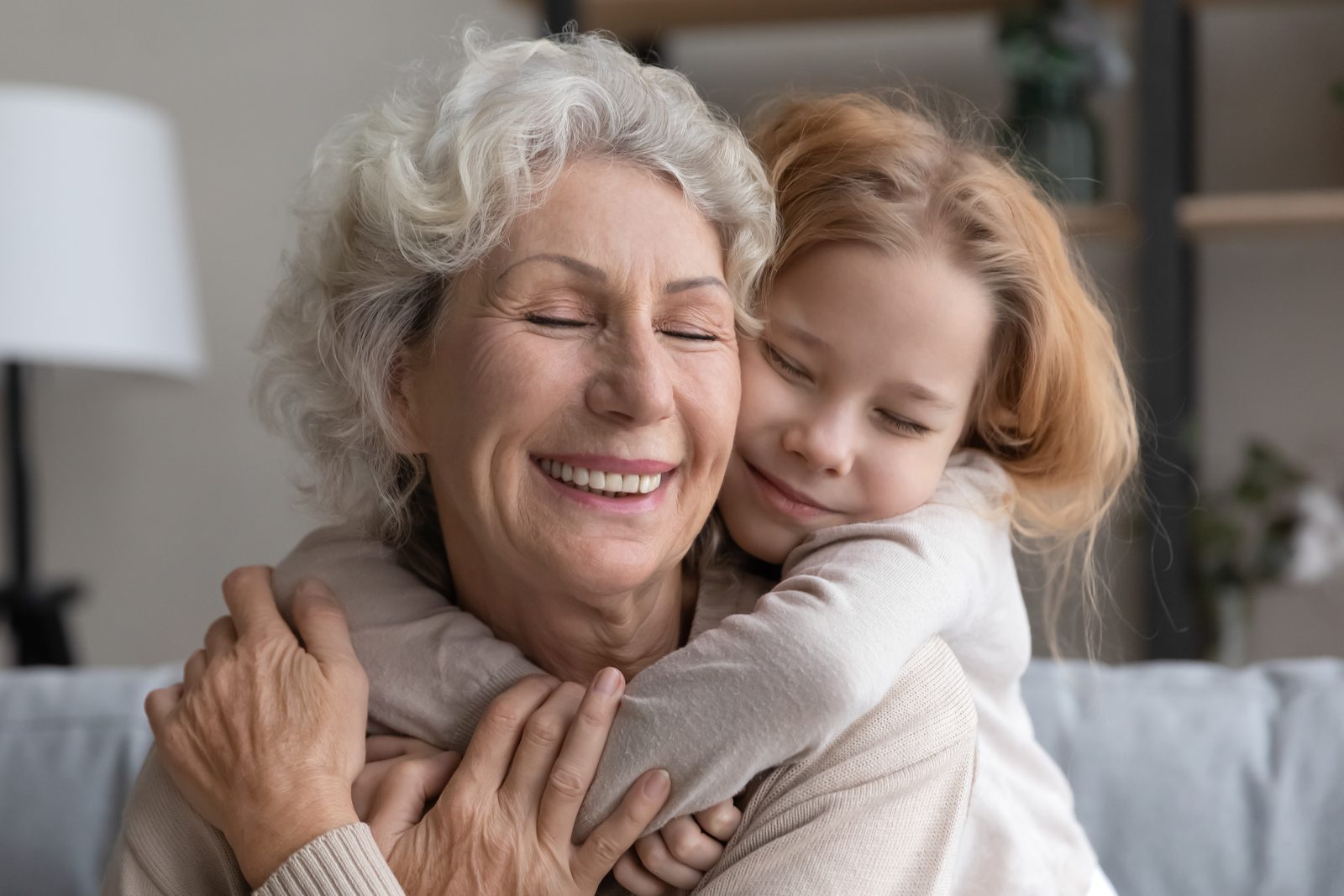 Grandmother embracing her grandchild at home