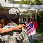 Soldier in uniform reuniting with his young daughter