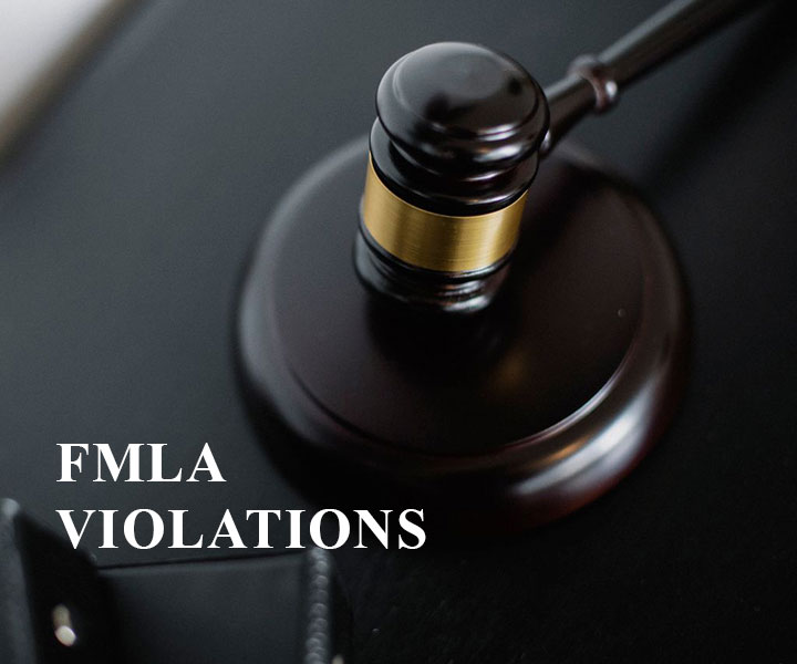 A judge’s gavel resting on a table with the text “FMLA VIOLATIONS” written beside it.