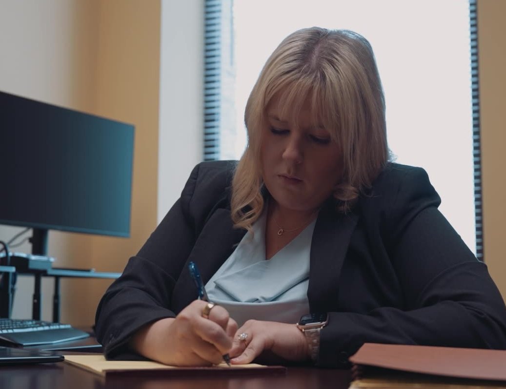 Klie Law Offices family law attorney Klie Law Offices family law attorney reviewing case notes at her desk