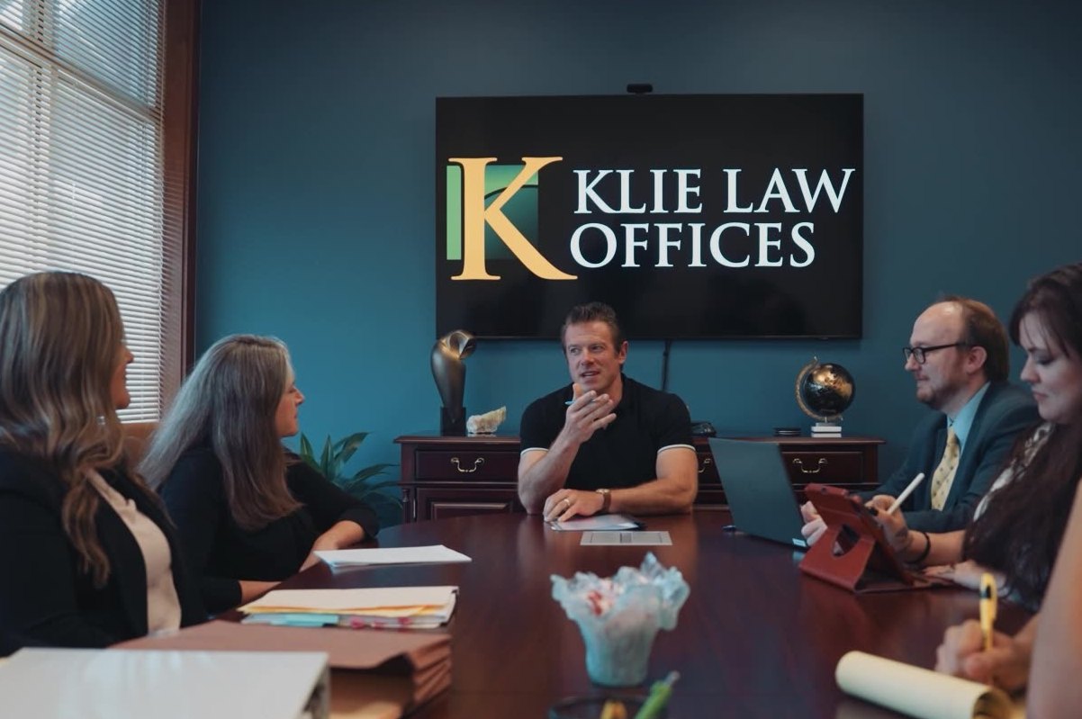 Klie Law Offices attorneys and staff meeting in the firm's conference room