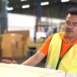 Warehouse worker holding his lower back after an injury